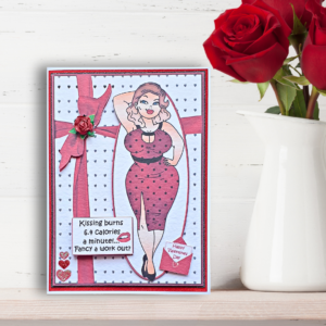 Foxy Lady - Kissing Burns Calories Valentine's Card displayed on a Wooden shelf wth a vase of red roses in front of a white painted brick wall