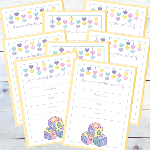 PD Whitewashed boards show a pack of eight Heart & Baby Blocks Birth Announcements with double heart drop bunting, and baby blocks at the bottom. Wording reads Announcing the arrival of and then spaces for Date, Time, Weight and love from. Pictured with yellow envelopes.